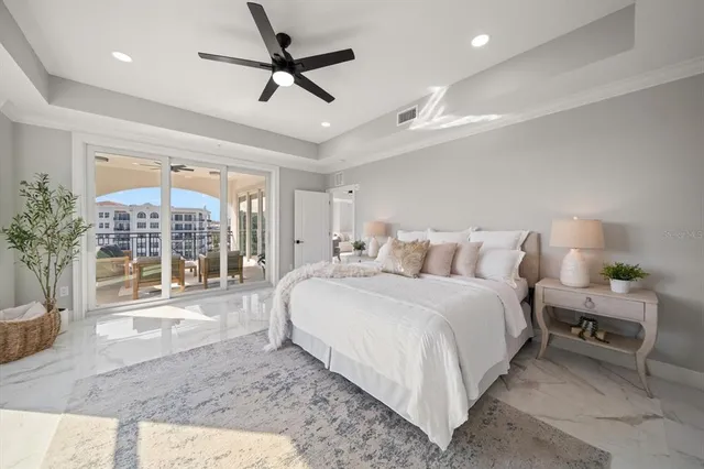 a spacious bedroom with a large bed and a large window