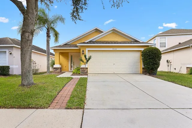 a front view of a house with a yard
