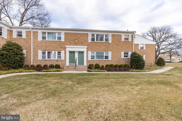 a front view of house with yard and trees around