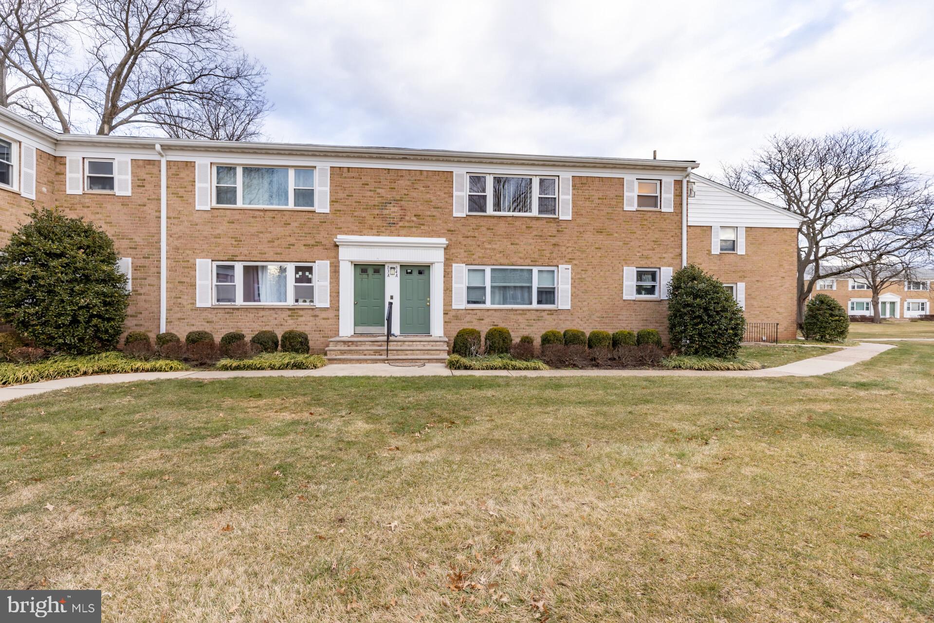 a front view of house with yard and trees around