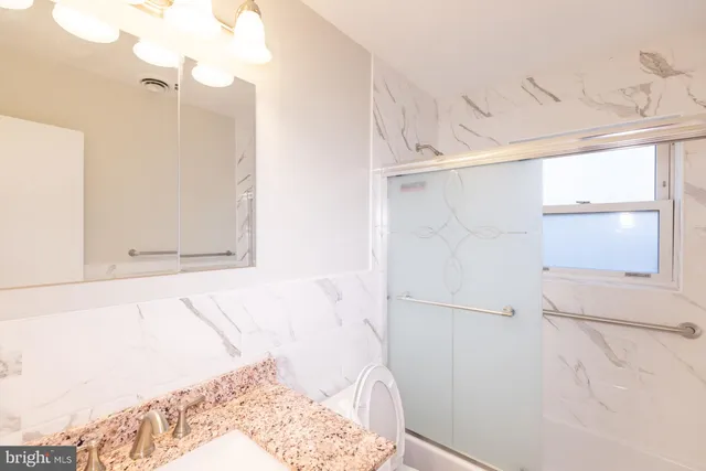 a bathroom with a bathtub and shower