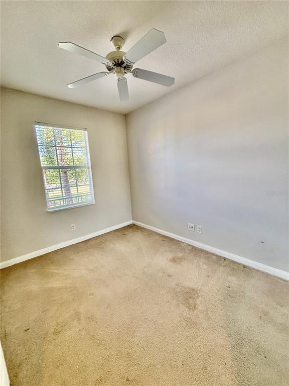 7892 Farina Court Sarasota, FL 34238 - Photo 11 of 41 an empty room with windows and fan