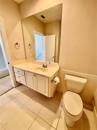 a bathroom with a sink mirror vanity and toilet