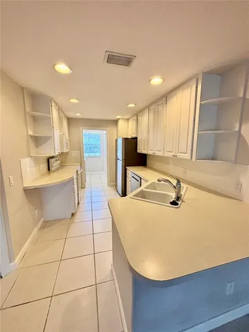 a kitchen with stainless steel appliances granite countertop a sink and a stove