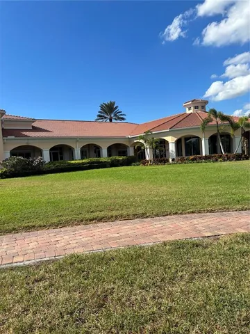 a front view of a house with a garden and yard