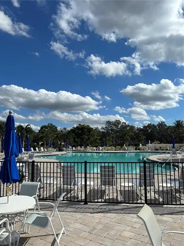 a view of a swimming pool with outdoor seating