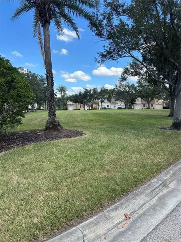 a view of outdoor space with swimming pool and trees in the background