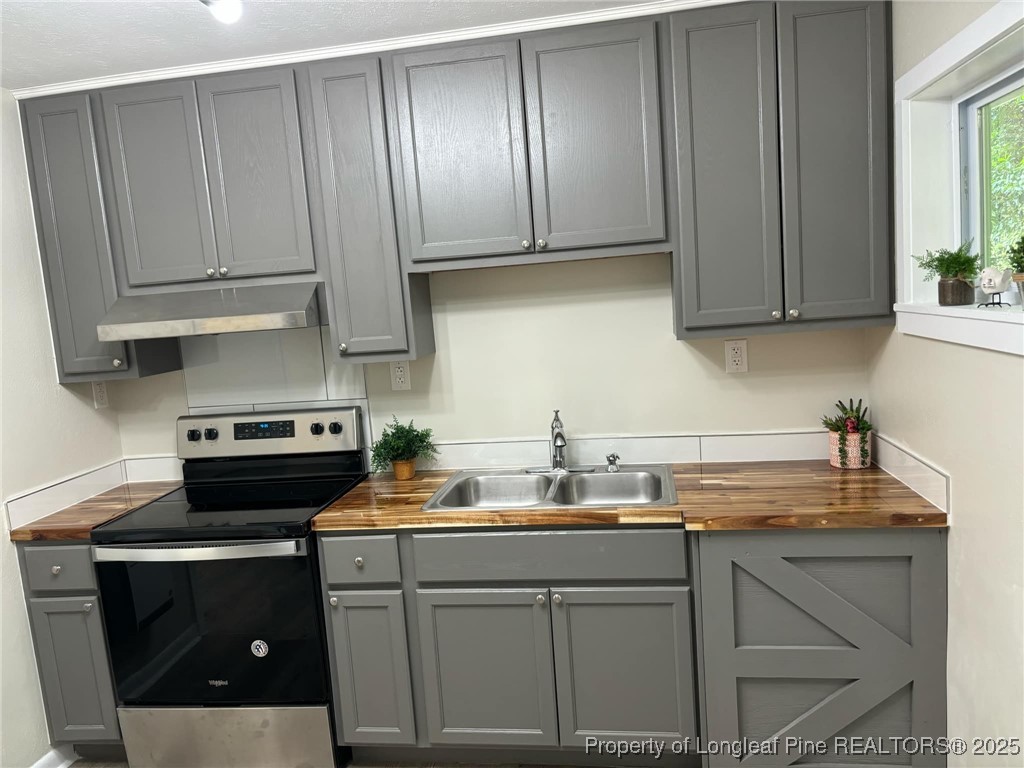a kitchen with a sink cabinets and appliances
