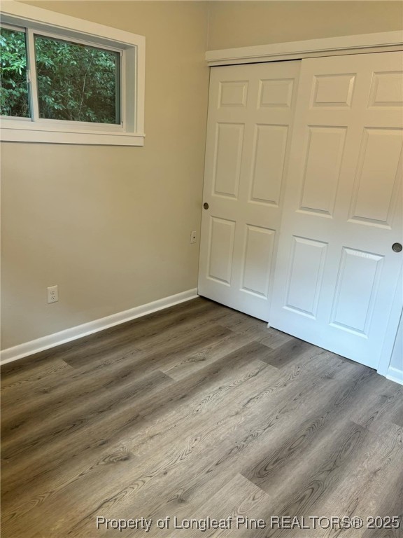 432 Squirrel Street, Unit A Fayetteville, NC 28303 - Photo 7 of 9 a view of empty room with wooden floor and fan