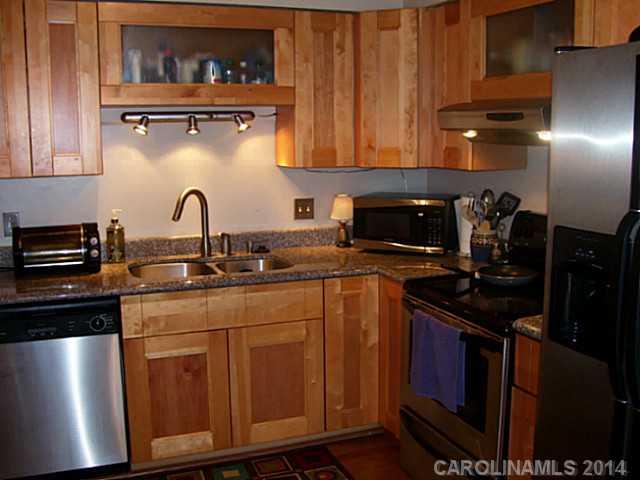 4723 Rounding Run Road, Unit 5 Charlotte, NC 28277 - Photo 4 of 12 a kitchen with stainless steel appliances granite countertop a stove a sink and a microwave