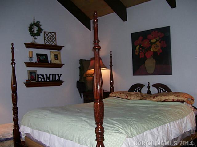 4723 Rounding Run Road, Unit 5 Charlotte, NC 28277 - Photo 5 of 12 a bedroom with a bed and a painting on the wall
