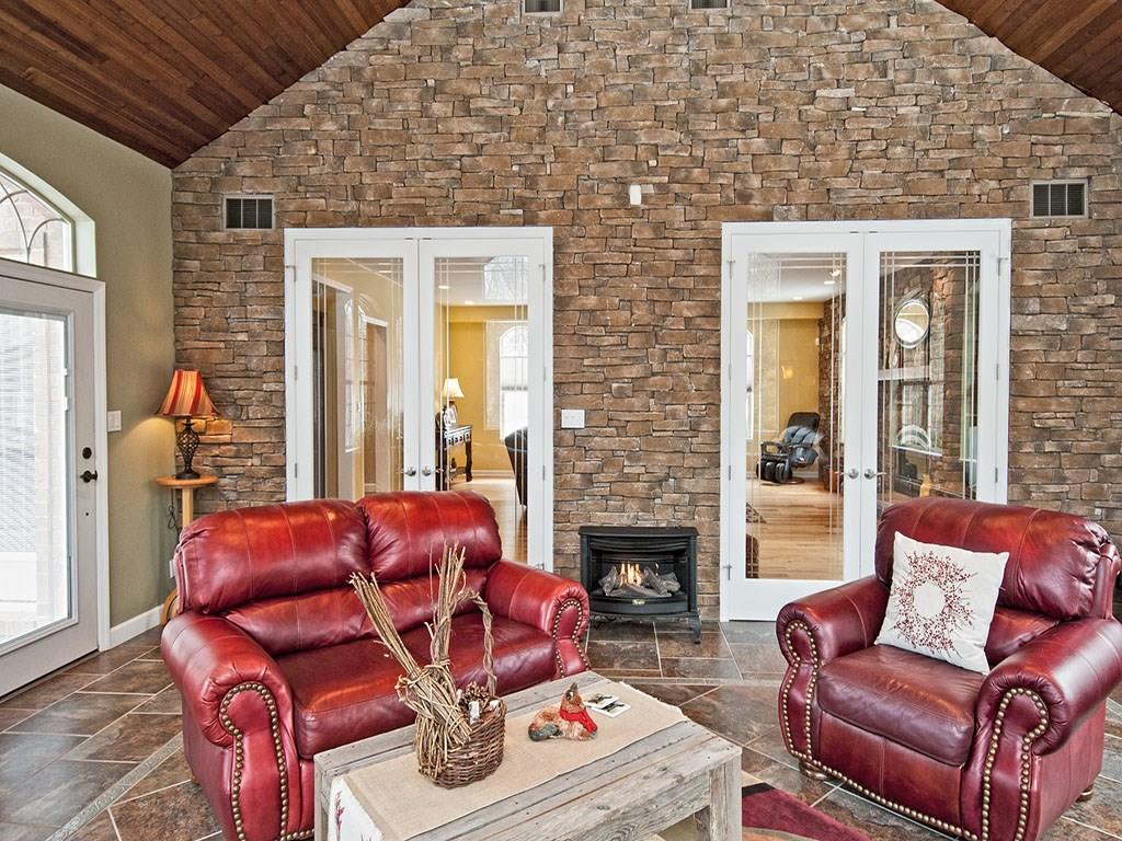835 Old Mill Road Fox Chapel, PA 15238 - Photo 12 of 25 Stone accent wall with gas stove fireplace. 9 foot doors.