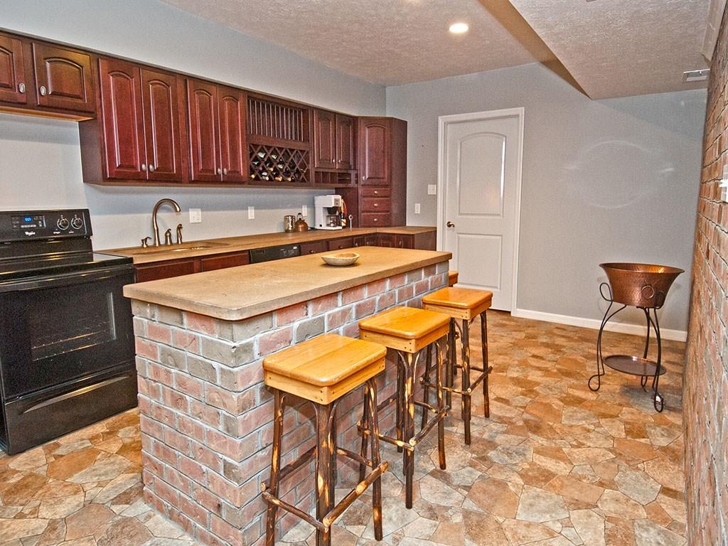 835 Old Mill Road Fox Chapel, PA 15238 - Photo 21 of 25 A full second kitchen in the lower level with brick island makes food prep and entertaining in the game room or outside patio easy and fun.