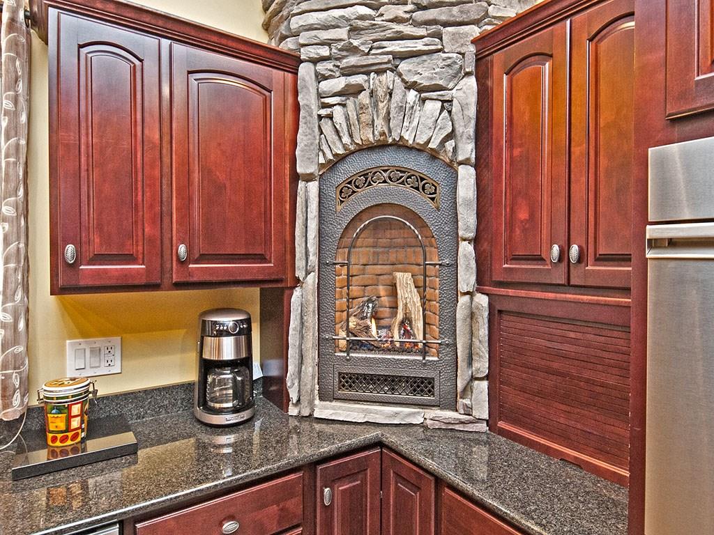835 Old Mill Road Fox Chapel, PA 15238 - Photo 7 of 25 The kitchen fireplace of one of 6 gas log burning fireplaces with imported stone surrounds throughout the home.