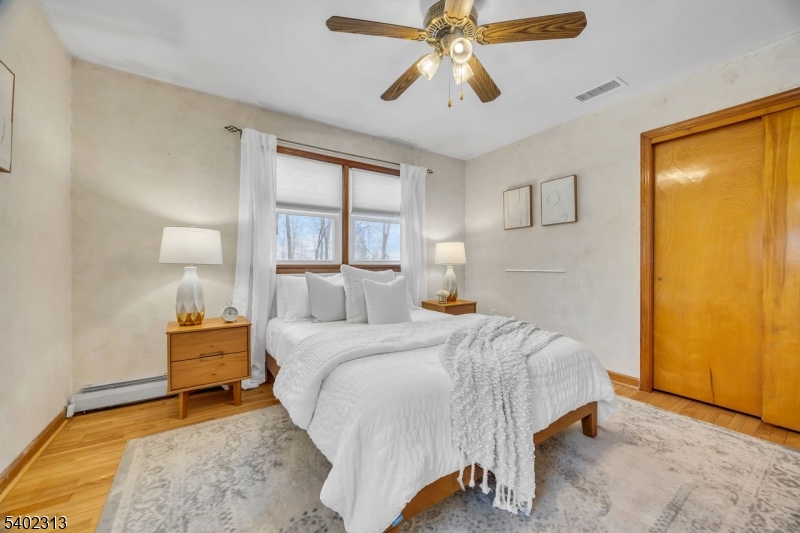 128 Old Croton Road Flemington, NJ 08822 - Photo 19 of 35 a bedroom with a bed and a chandelier