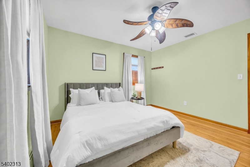 128 Old Croton Road Flemington, NJ 08822 - Photo 22 of 35 a bedroom with a bed and a chandelier