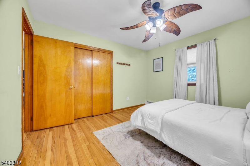128 Old Croton Road Flemington, NJ 08822 - Photo 23 of 35 a bedroom with a bed and a chandelier