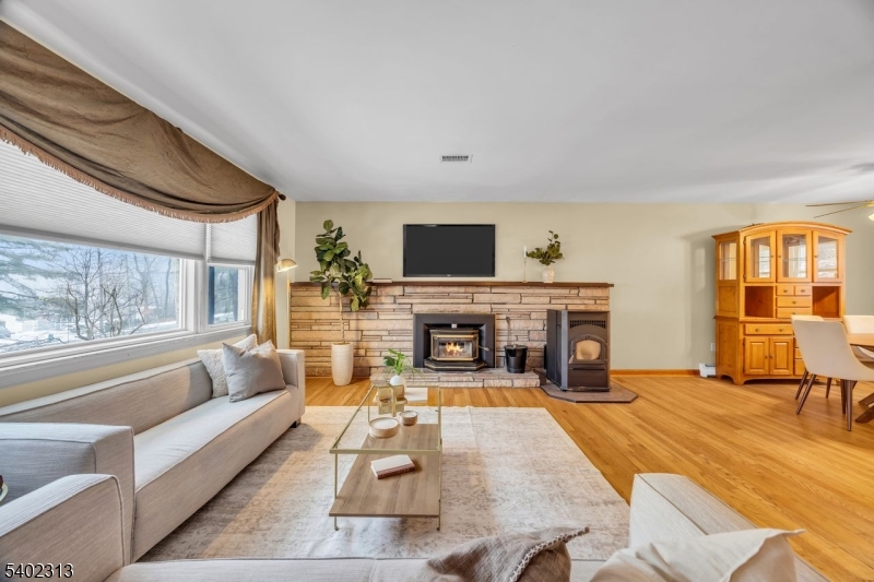 128 Old Croton Road Flemington, NJ 08822 - Photo 6 of 35 a living room with furniture a fireplace and a flat screen tv