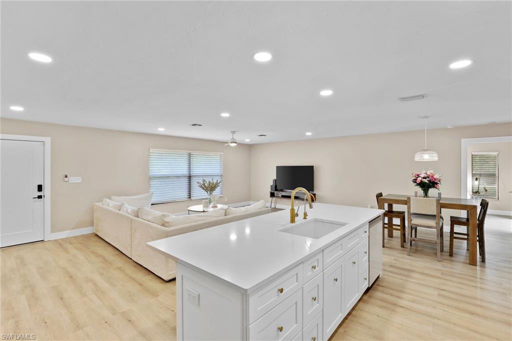 3221 68th Street Southwest Naples, FL 34105 - Photo 11 of 38 a large white kitchen with sink and a large window
