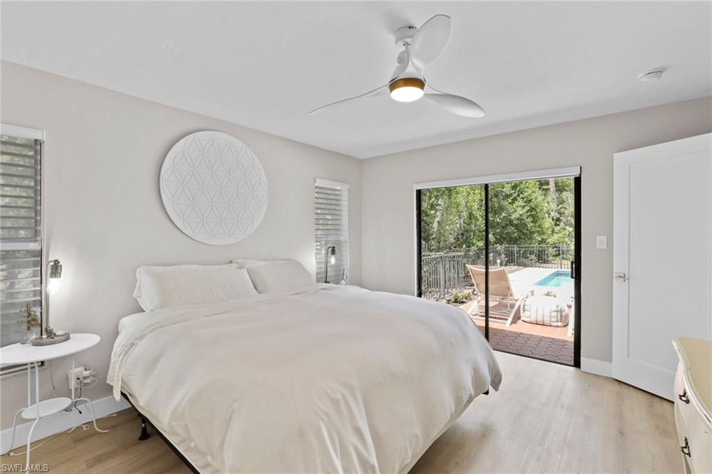 3221 68th Street Southwest Naples, FL 34105 - Photo 14 of 38 a bedroom with a bed and a large window