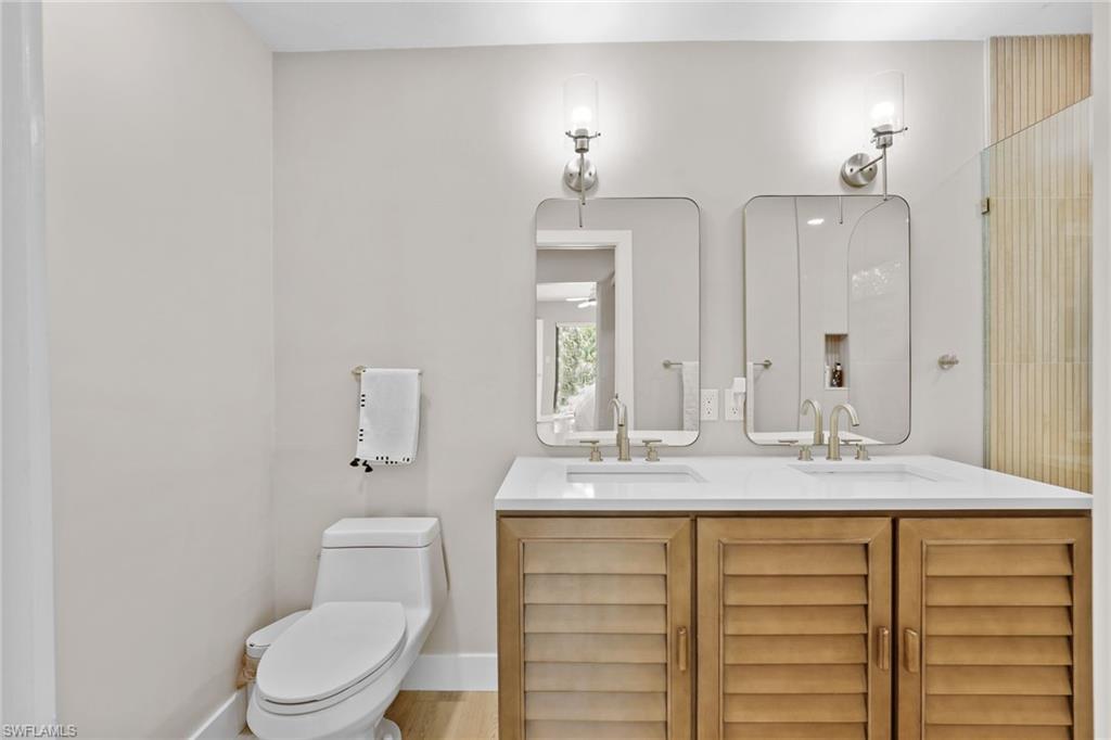 3221 68th Street Southwest Naples, FL 34105 - Photo 15 of 38 a bathroom with a granite countertop sink toilet and mirror