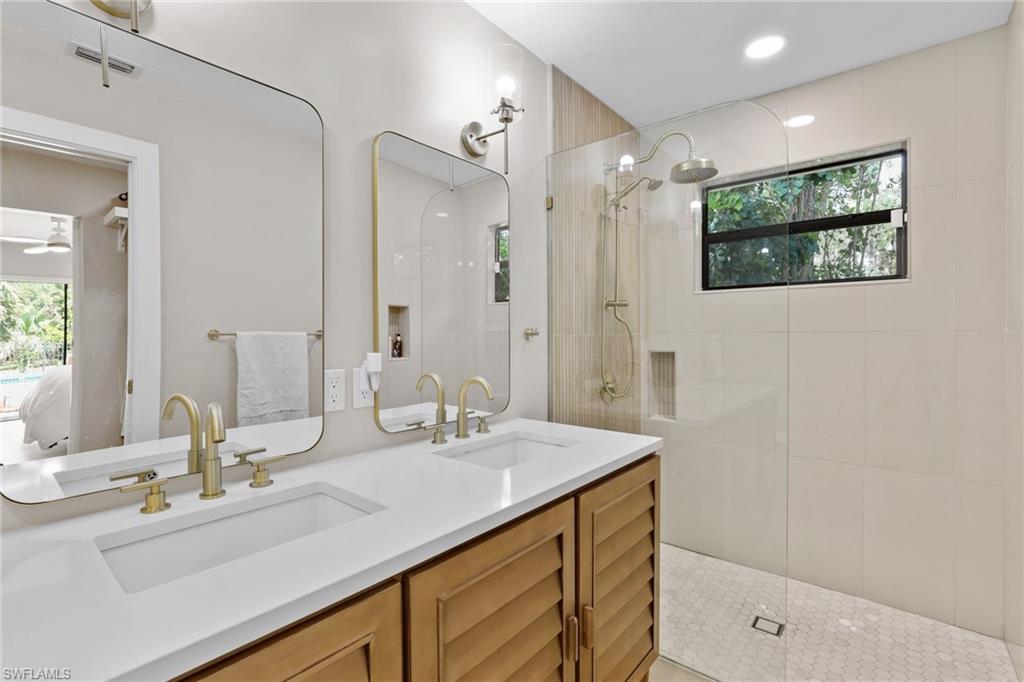3221 68th Street Southwest Naples, FL 34105 - Photo 16 of 38 a bathroom with a double vanity sink mirror and double