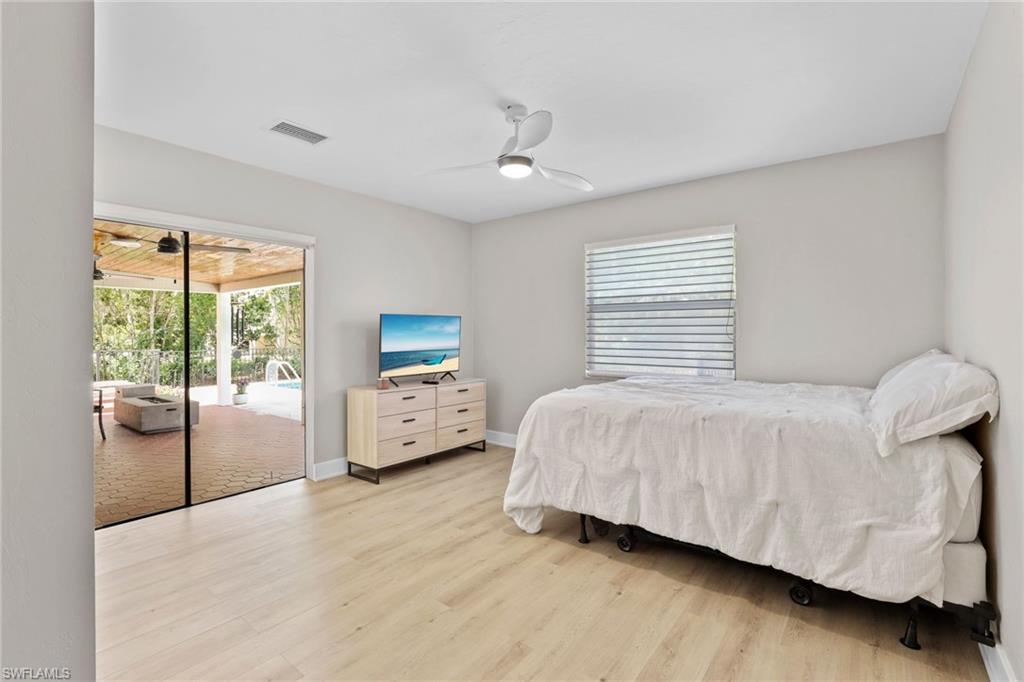 3221 68th Street Southwest Naples, FL 34105 - Photo 19 of 38 a bedroom with a bed and a large window