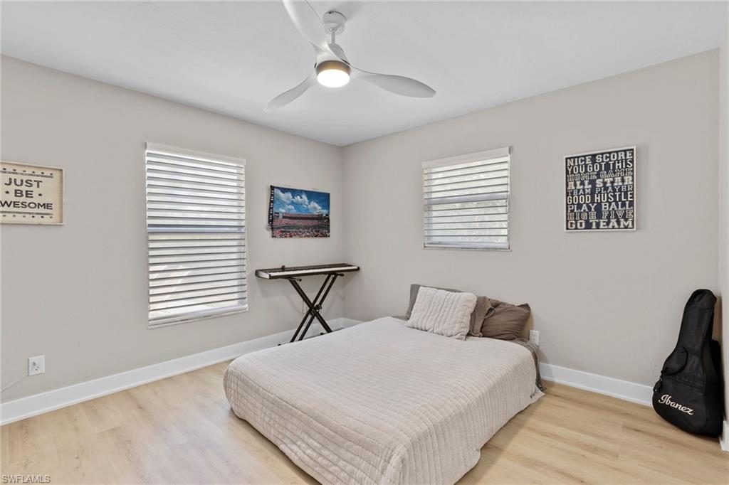 3221 68th Street Southwest Naples, FL 34105 - Photo 20 of 38 a bedroom with a bed and a chair