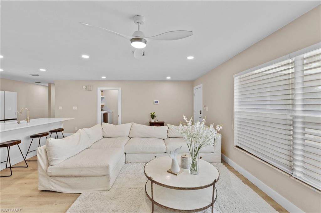 3221 68th Street Southwest Naples, FL 34105 - Photo 2 of 38 a living room with furniture and a table