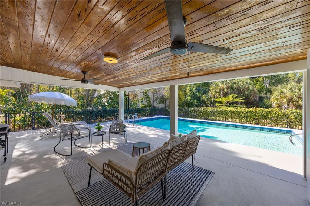 3221 68th Street Southwest Naples, FL 34105 - Photo 25 of 38 a building outdoor space with patio furniture and potted plants