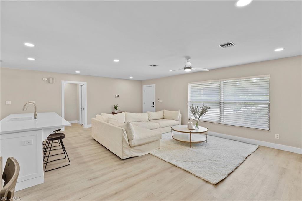 3221 68th Street Southwest Naples, FL 34105 - Photo 3 of 38 a living room with furniture and a large window