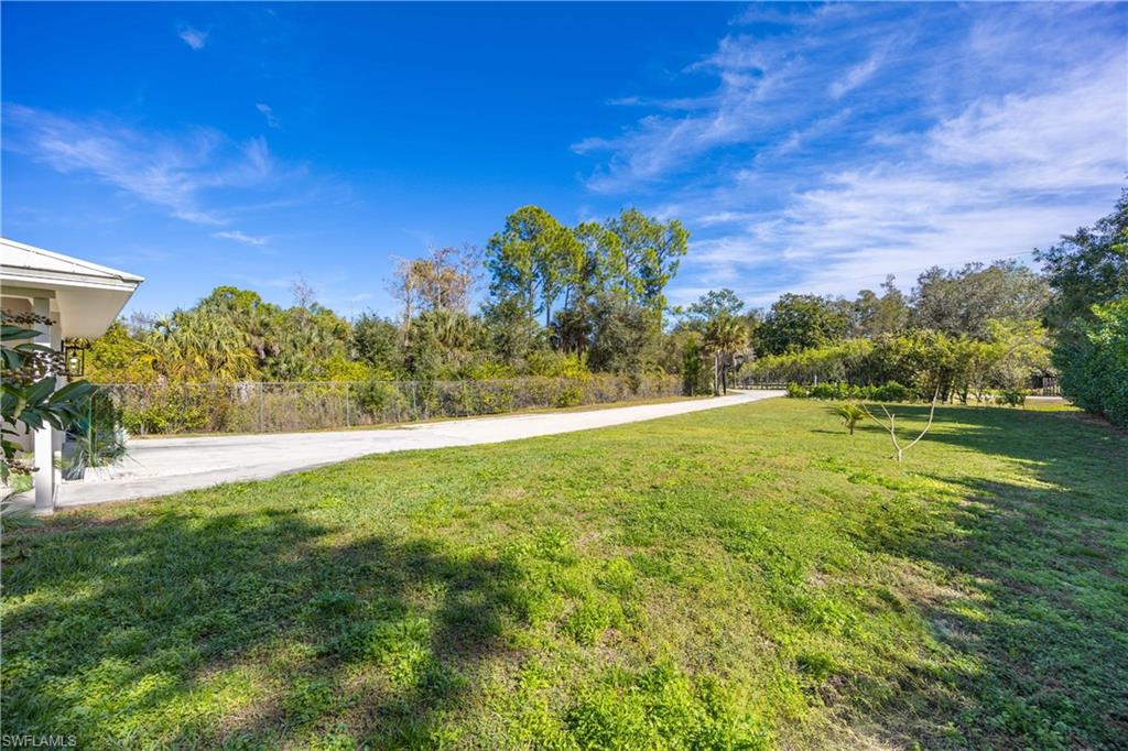 3221 68th Street Southwest Naples, FL 34105 - Photo 34 of 38 a view of a garden with a building in the background