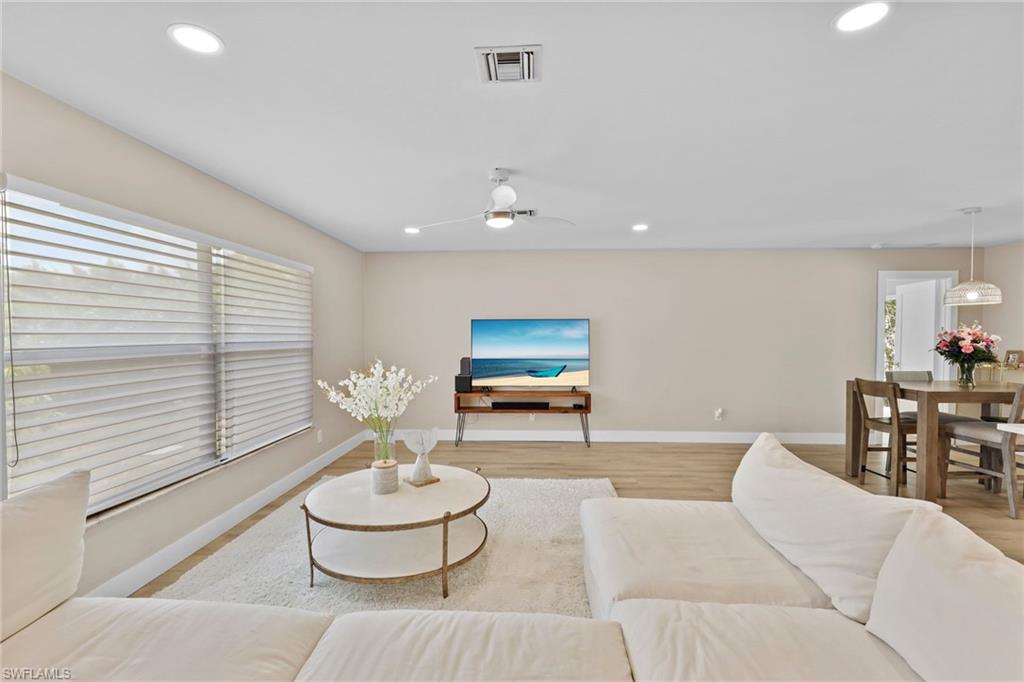 3221 68th Street Southwest Naples, FL 34105 - Photo 4 of 38 a living room with furniture and a large window