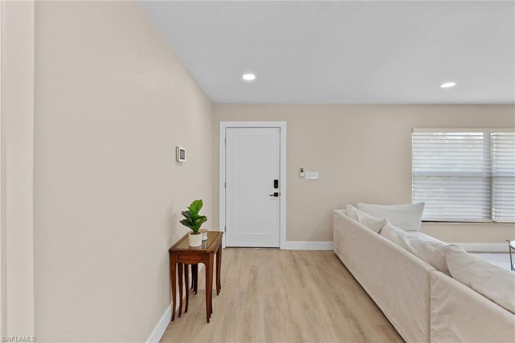 3221 68th Street Southwest Naples, FL 34105 - Photo 5 of 38 a hallway with a potted plant
