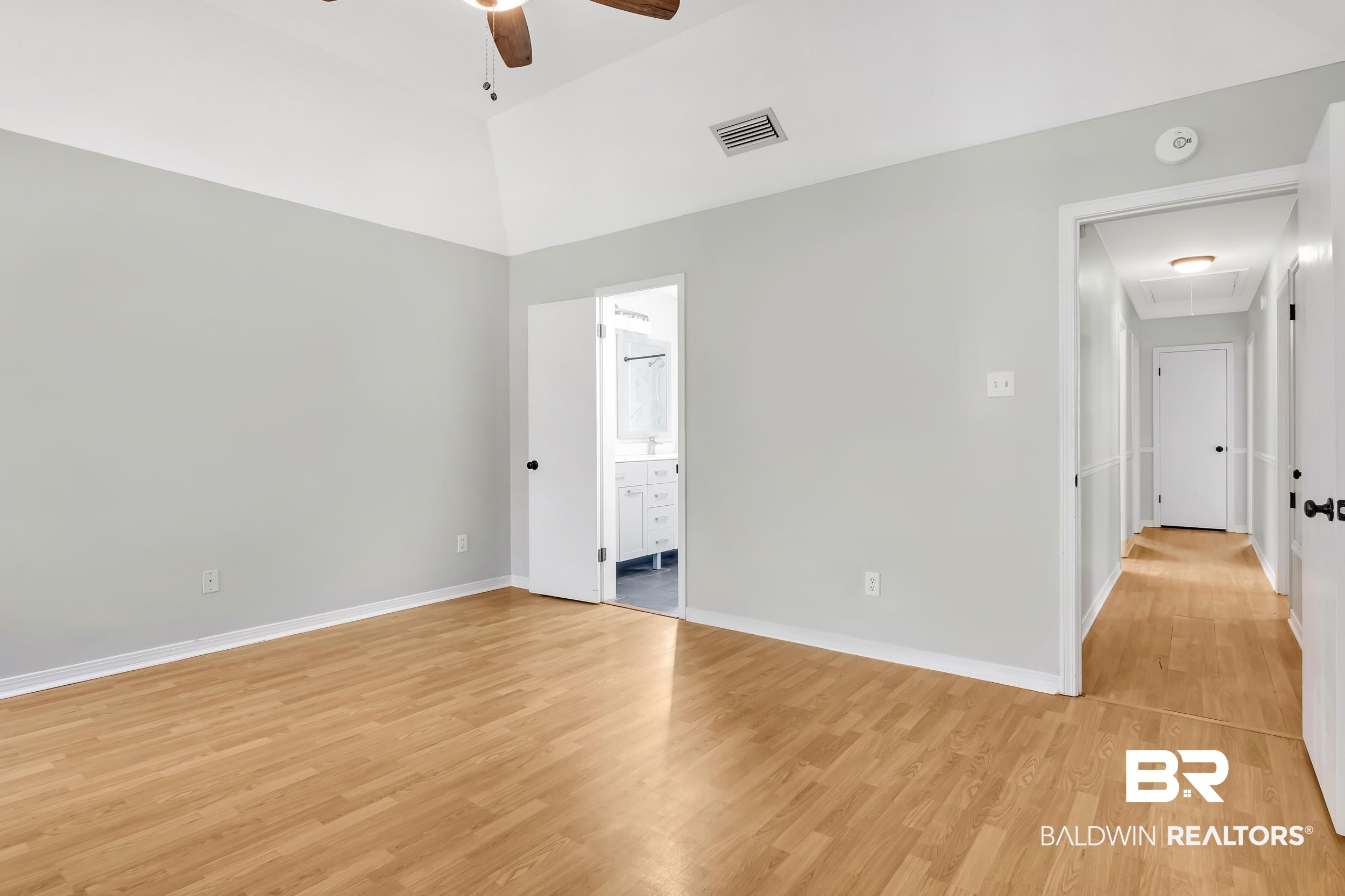 6616 Conde Court Mobile, AL 36695 - Photo 17 of 27 Unfurnished bedroom with visible vents, baseboards, attic access, light wood-style floors, and ensuite bathroom