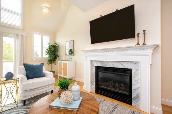 a living room with furniture flowerpot and wooden floor