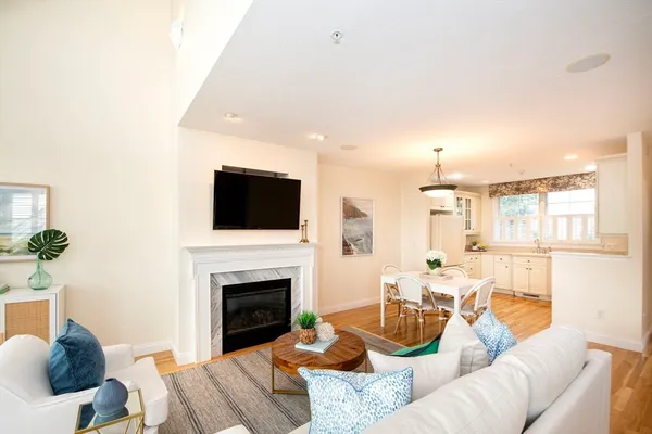 a living room with furniture a fireplace and a flat screen tv