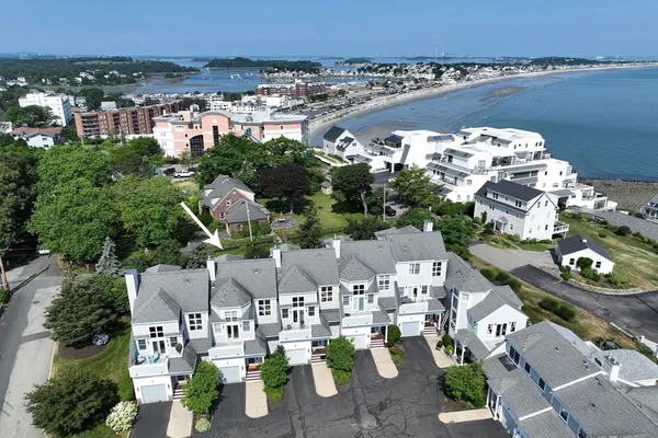 an aerial view of multiple houses with yard