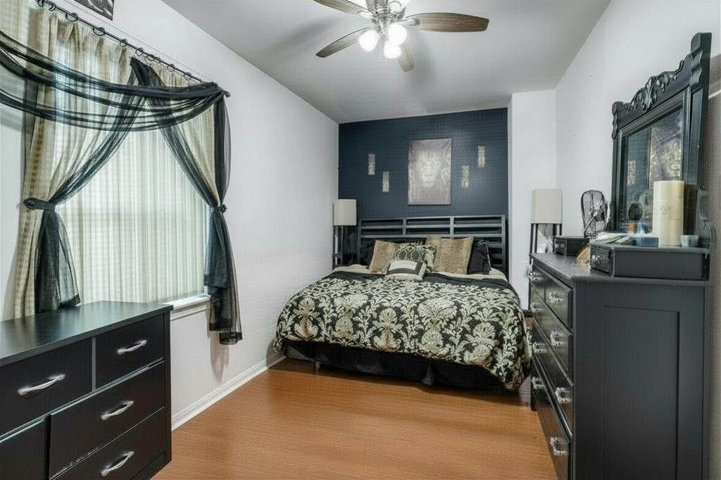 2317 Anderson Street Dallas, TX 75215 - Photo 10 of 14 Bedroom with a ceiling fan and an accent wall