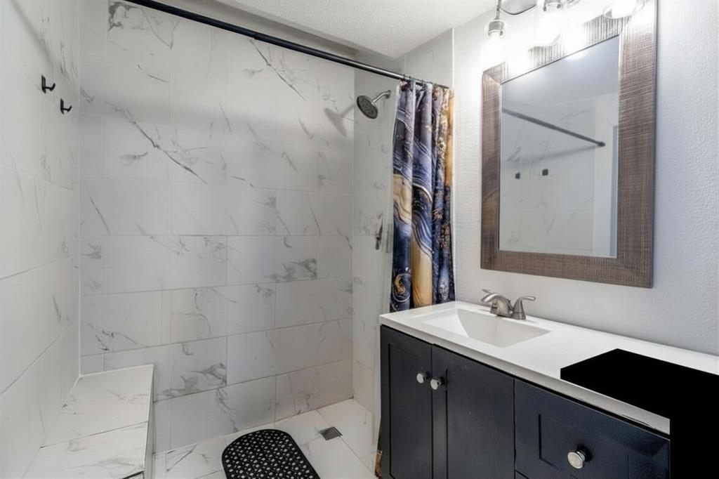 2317 Anderson Street Dallas, TX 75215 - Photo 11 of 14 Full bath featuring vanity and a marble finish shower