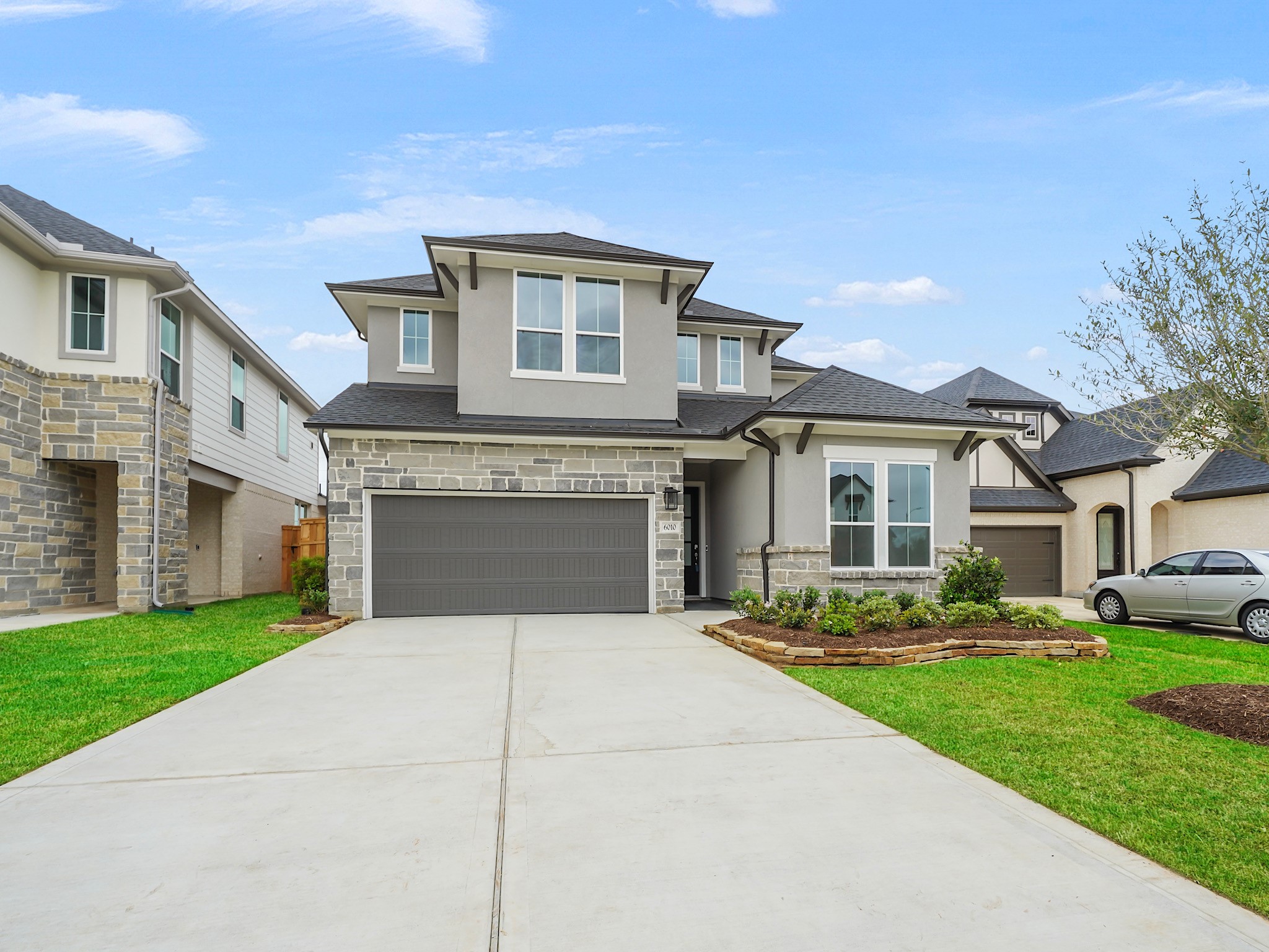 6010 Rolling Strm Court Fulshear, TX 77441 - Photo 2 of 23 Fall in love with this home's stunning curb appeal! A vibrant flower bed enhances the exterior, creating a welcoming first impression you won't forget.
