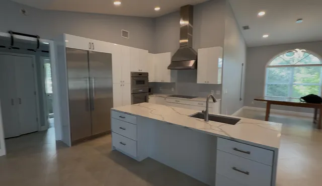 a kitchen with stainless steel appliances a sink and a large window