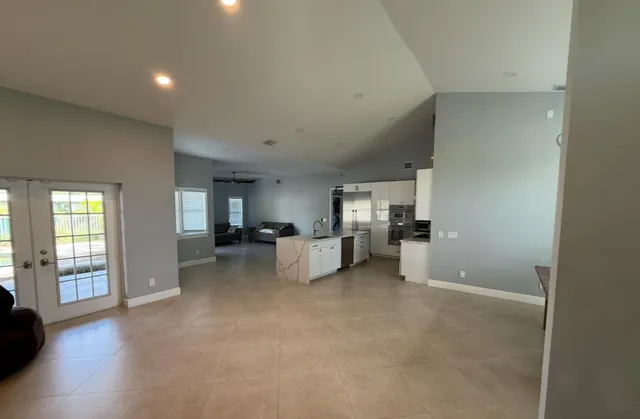 a view of a livingroom with furniture and a window