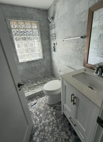 a bathroom with a sink toilet and shower