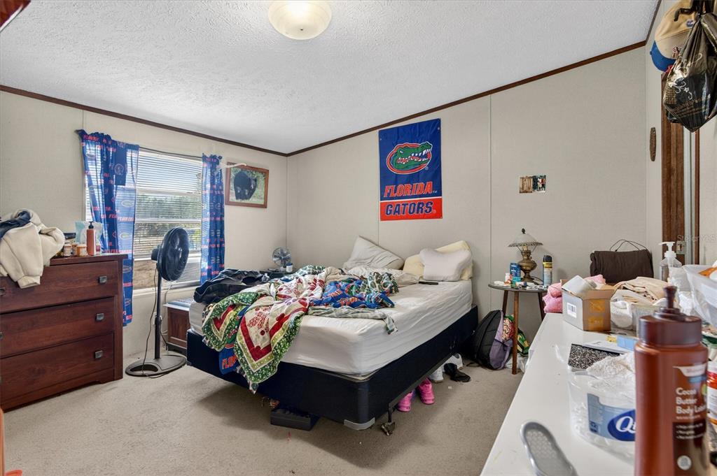 5083 Southeast 70th Loop Ocala, FL 34480 - Photo 12 of 34 a bedroom with bed and a window