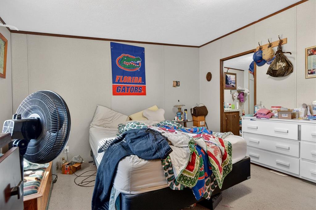 5083 Southeast 70th Loop Ocala, FL 34480 - Photo 13 of 34 a bedroom with a bed and cabinets