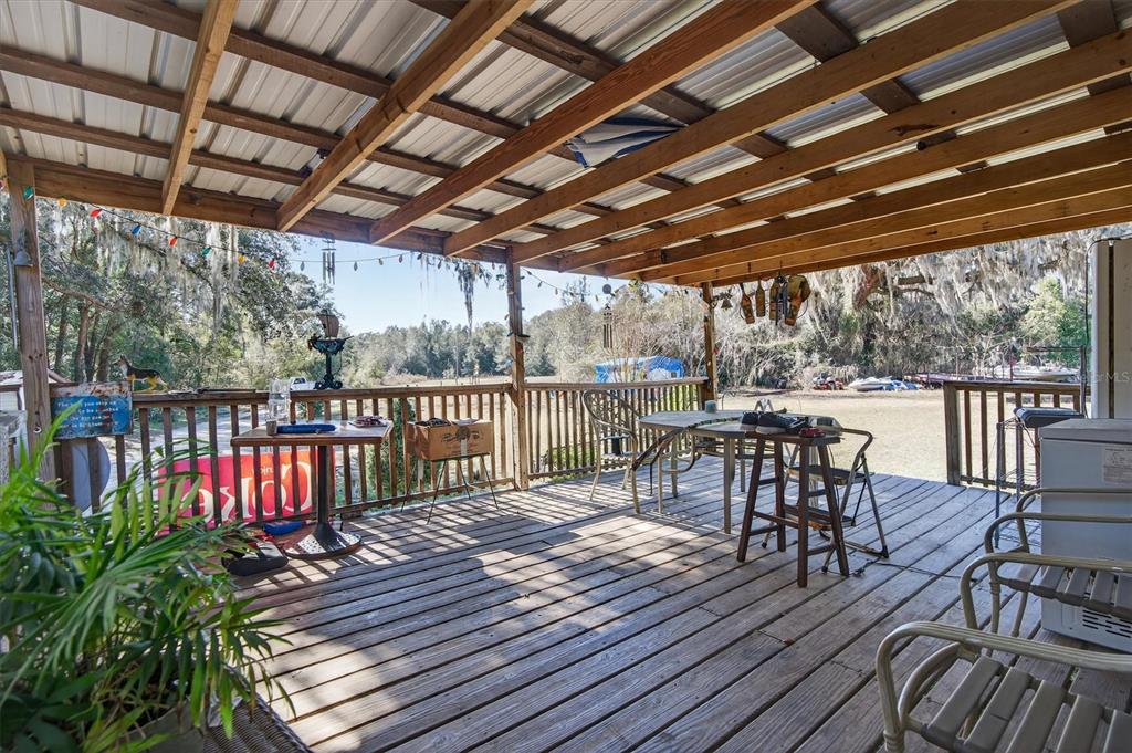 5083 Southeast 70th Loop Ocala, FL 34480 - Photo 2 of 34 a view of a chairs on wooden deck