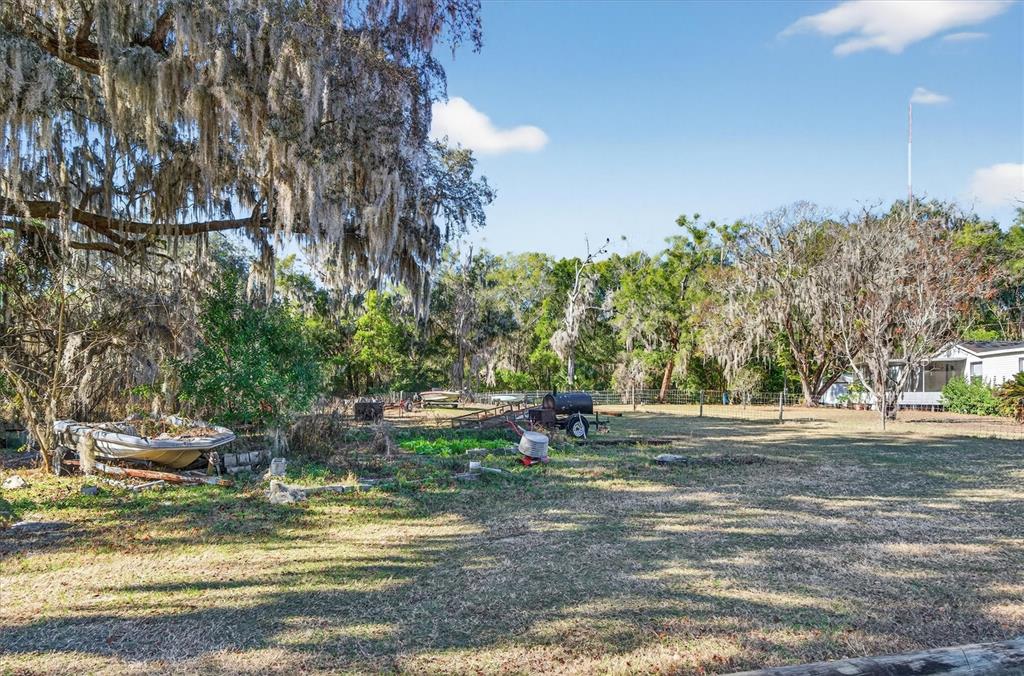 5083 Southeast 70th Loop Ocala, FL 34480 - Photo 33 of 34 a view of a fire pit with large trees