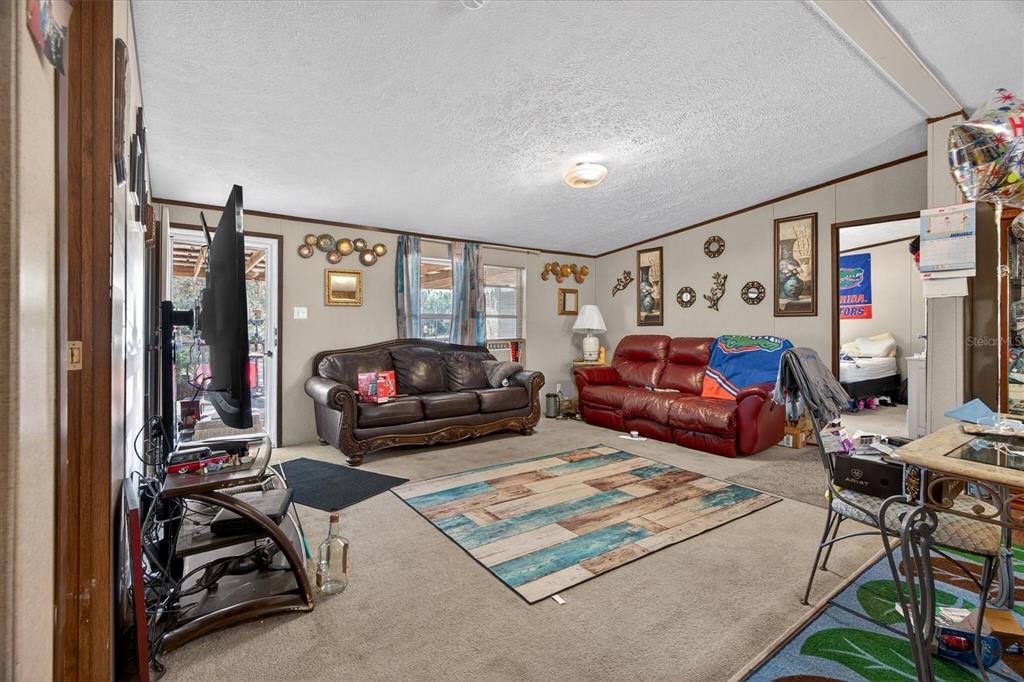 5083 Southeast 70th Loop Ocala, FL 34480 - Photo 7 of 34 a bedroom with furniture and a flat screen tv