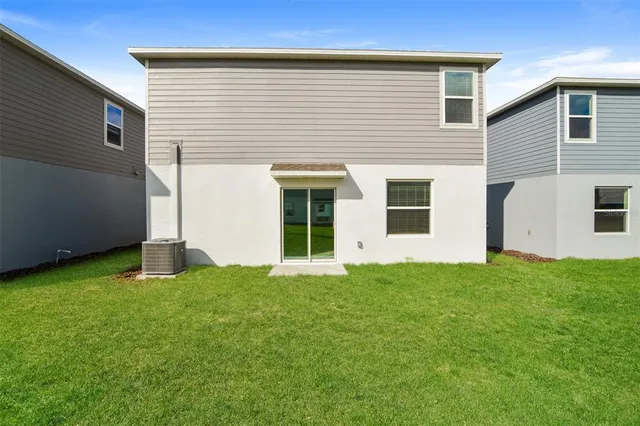a view of an house with backyard space and porch